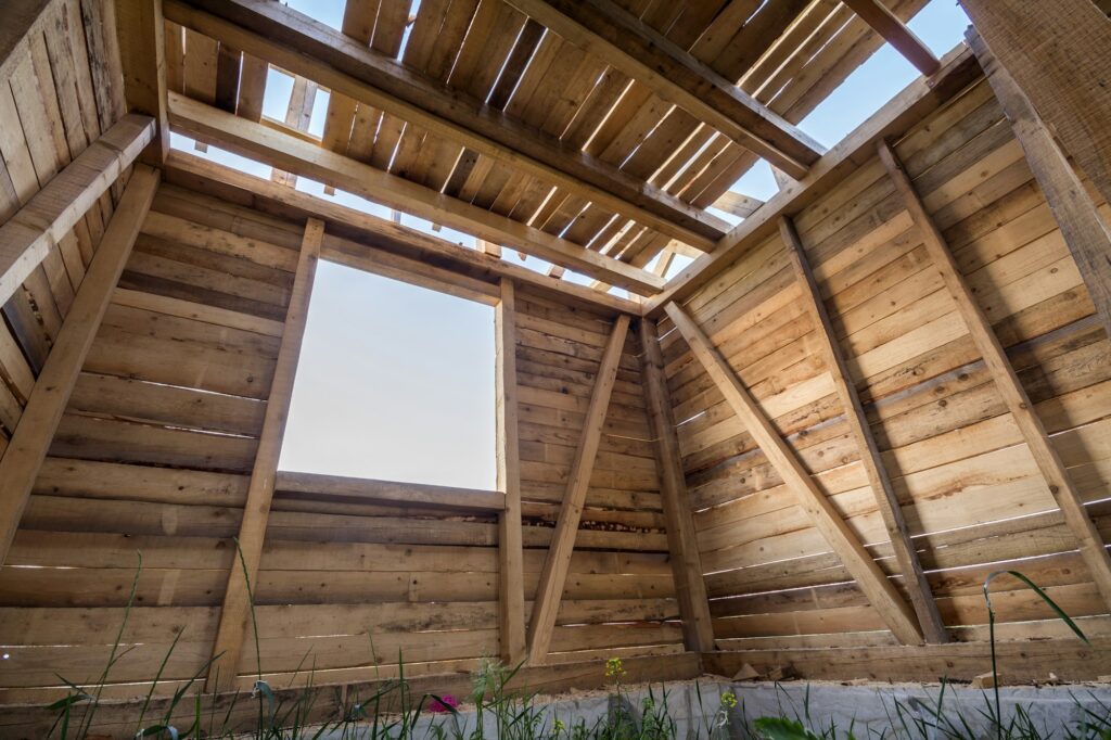 Close-up of walls and ceiling frame with windows openings from inside.