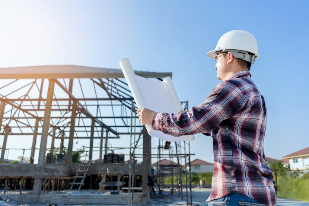 Foreman holding drawing project and looking for checking home project concept construction